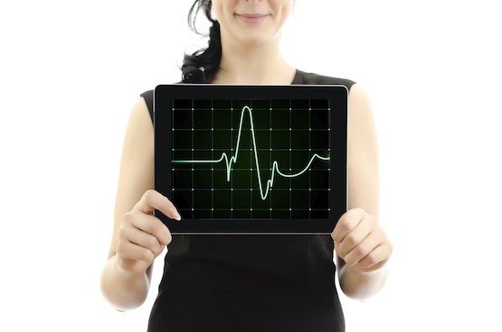 Woman holding tablet pc. Concept: cardiogram with heartbeat. isolated on white.